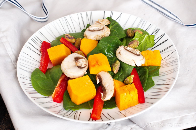This pumpkin spinach salad is a deliciously different salad - with pumpkin, spinach, red peppers, mushrooms and nuts. #salad